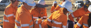 An image of Fitzroy to Gladstone Pipeline team members carrying a person on a stretcher as part of lifesaving skills training.